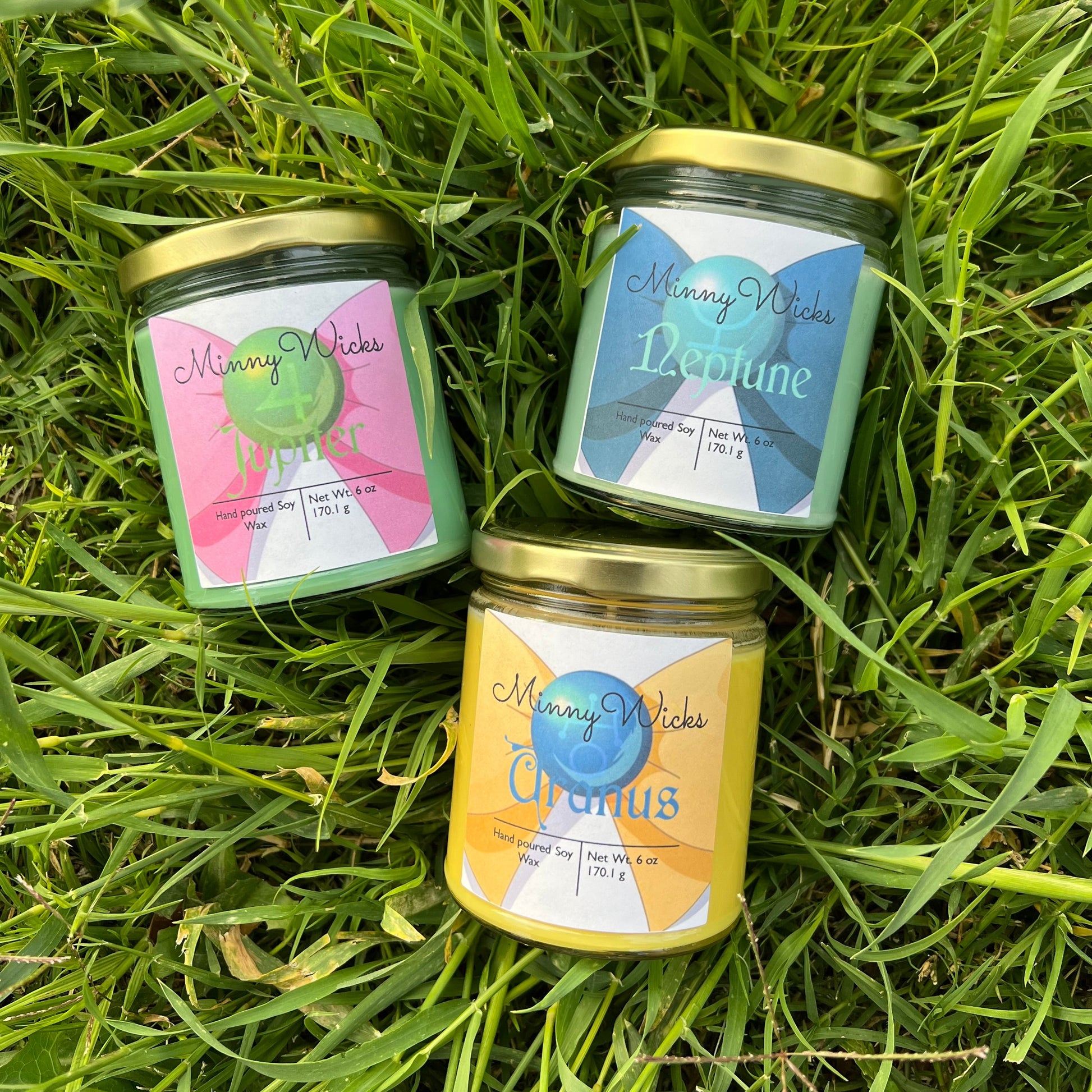 Three small jars with labels on a grassy background